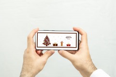 Holding a horizontal white screen smartphone with isolated background