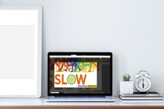 Laptop and picture frame with blank screen on wooden table.