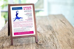 Mock up blank advertising whiteboard with easel standing on wood table in cafe and bar restaurant for display or montage of design space for text